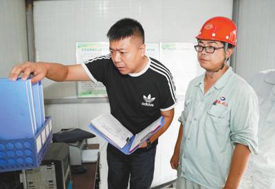  2017年8月19日，在河北冀春化工有限公司，沧州督查组队员在查看企业数据记录。新华社记者 才 扬摄